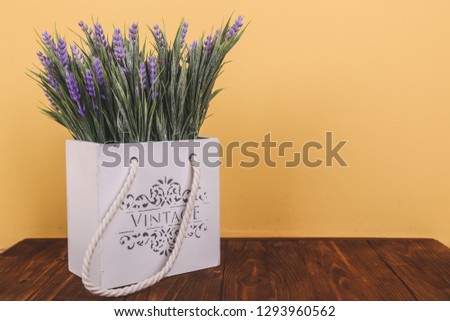 Object photography of a notepad on a wooden background with flowers.