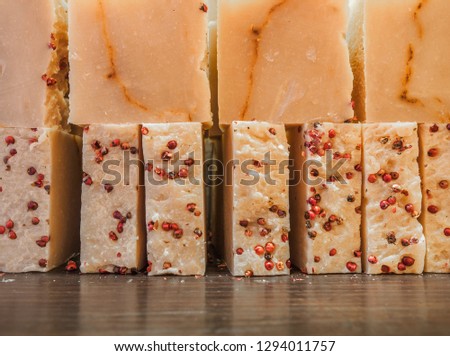 Bars of soap on a shop window. Fruit soap with natural cedar oil and herbal ingredients. Handmade natural cold process soap. Eco-friendly exfoliating soap for hair and body