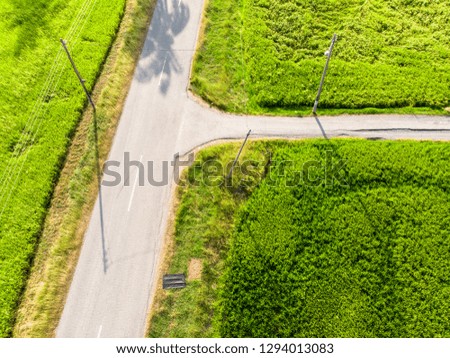 aerial view of t-juction with no car in paddy field plantation