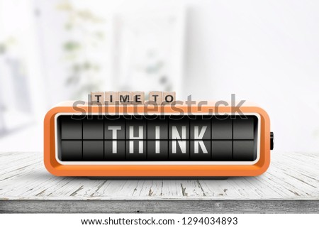 Time to think text on an old alarm clock in a bright room on a table