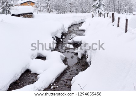 Winter stream with snow at early morning in Austria, Europe.