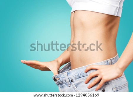 Health and beauty - woman in cotton underwear showing slimming concept