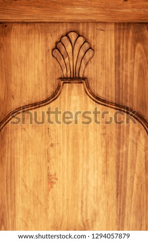 Ornate carvings in wooden door with copy space
