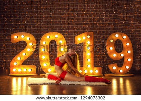 beautiful woman doing yoga on the Christmas background