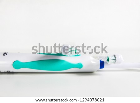 Electrical toothbrush on a soft light background.