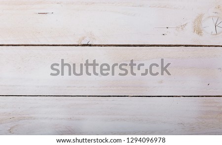 Old white soft wood pattern as background. Wooden planks on a wall or floor with texture. Light neutral flat faded tones.