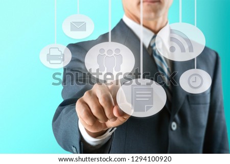 Businessman and analytics symbols on grey background