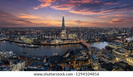 Panoramic view to the urban skyline of London, UK, along the river Thames just after sunset time