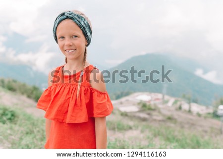 Portrait of beautiful kid on summer vacation in mountains
