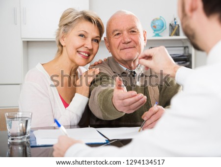 Old man and woman buy apartment under contract and get keys from agent