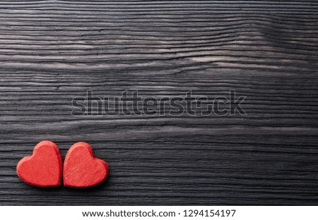 Two decorative hearts on a dark wooden background with copy space. top view. Valentine's Day card. Design element for romantic greeting card, wedding invitation,