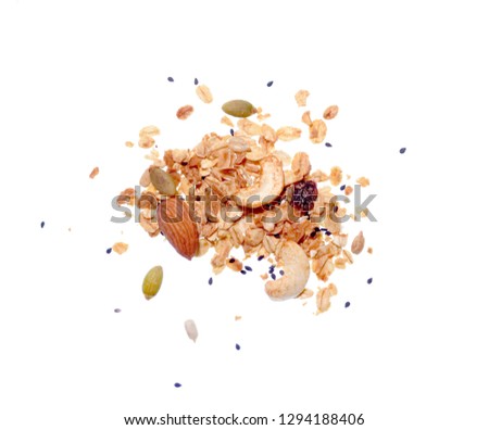 Top view close up photo image of granola pile isolated on white background, muesli grain texture, scattered seeds pattern, cereal food for good health.