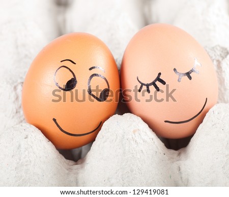 two funny smiling eggs in a packet.