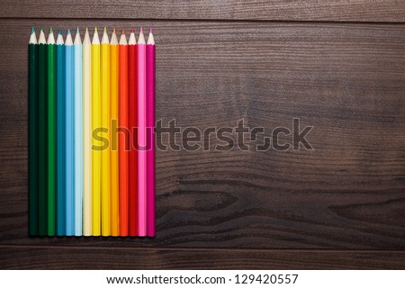 colorful pencils on the brown wooden table