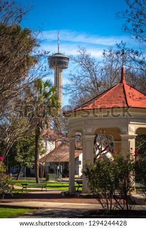 Tower (Tower of Americas) as seen from a park with a gazebo in a nearby neighborhood in San Antonio, Texas