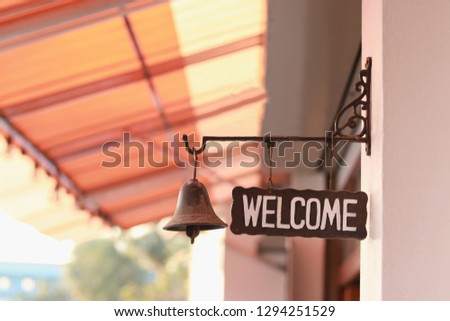 welcome sign hang at the wall of the entrance door
