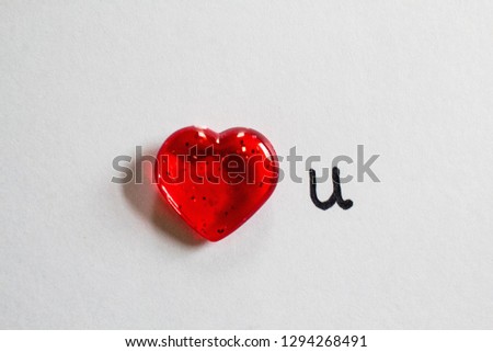 Valentine's Day greeting with a clear red heart and "I love you" handwritten note, on white background. Suitable for personal note, greeting card, banner, background or webpage/blog