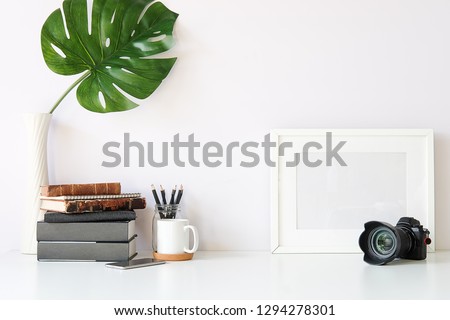 Mockup workspace desk and copy space books,plant and coffee on white desk.  Royalty-Free Stock Photo #1294278301