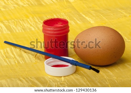 watercolors brush and easter eggs on yellow background