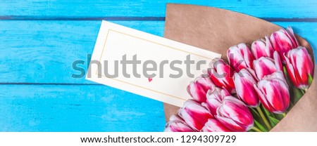 Bouquet of red tulips for the holiday women's day and valentine's day on the background of wooden boards.