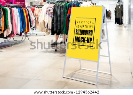Mock up vertical blank banner or signboard with clipping path to show promotion or discount in shop clothing, Yellow screen empty space for insert text or advertising in shopping mall