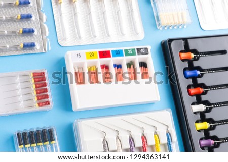 Endodontic instruments. Set of dental instruments on blue. Endodontic files in plastic containers on blue.  Royalty-Free Stock Photo #1294363141