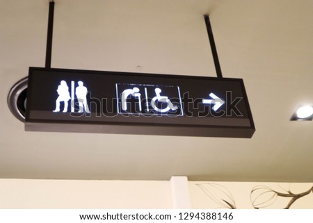toilet with man and women signs at shopping mall.