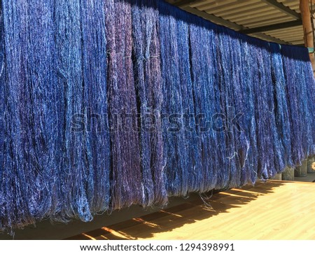 The silk thread from the mulberry worm was dyed indigo. They were dried in the sun after the dye was finished. After they are dried, they will be woven into the fabric.