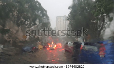 Dangerous vehicle driving in the heavy rain and slippery road. Abstract blurred bad weather car on the heavy traffic