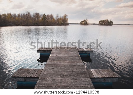 View of a pathway of a pier from a lake in Sweden
