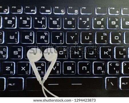 Earphons on keyboard background