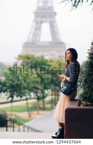 Beautiful girl on the background of the Eiffel Tower in Paris in France