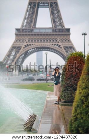 Beautiful girl on the background of the Eiffel Tower in Paris in France