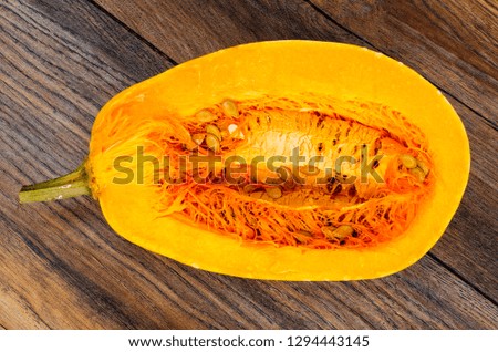 Sliced ripe pumpkin on wooden table. Studio Photo

