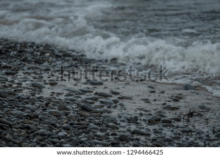 Sea waves and stones background. Black Sea. Waves washing down rocky beach.