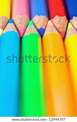 assorted colour pencils close up in perspective with focus on the tips using a shallow depth of field