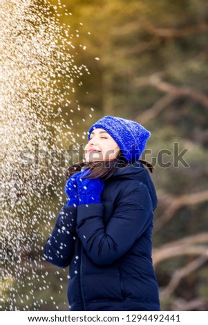 winter portrait of a girl in a hat on a walk, frost and snow