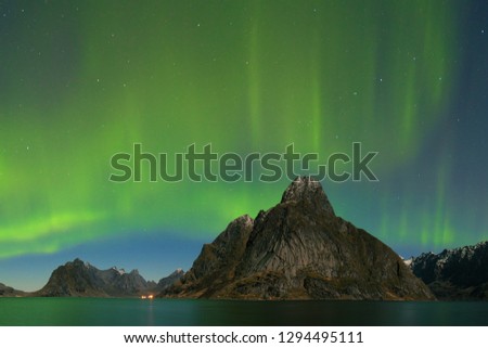 Aurora borealis dancing on mountain in fishing village at Reine and Sakrisoy, Lofoten, Norway
Visiting the Lofoten Islands during winter time is a dream for all landscape photographers. 