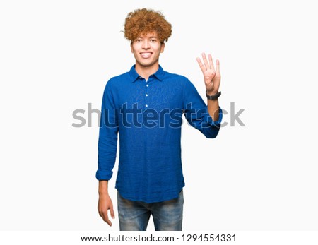 Young handsome elegant man with afro hair showing and pointing up with fingers number four while smiling confident and happy.
