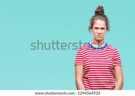 Beautiful brunette curly hair young girl wearing casual look over isolated background skeptic and nervous, frowning upset because of problem. Negative person.