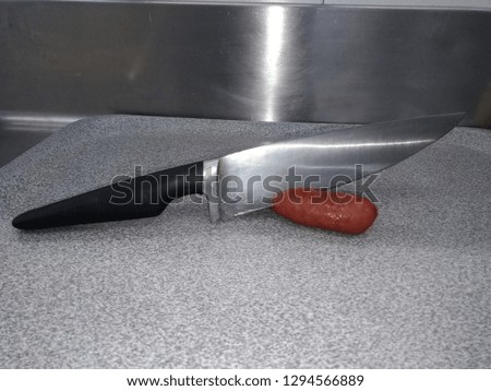 knife cutting chorizo