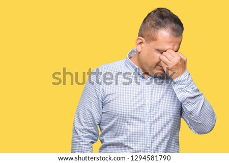 Middle age arab business man over isolated background tired rubbing nose and eyes feeling fatigue and headache. Stress and frustration concept.
