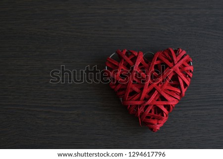 Red wicker heart on wooden background.Valentine's day concept . Copy space.