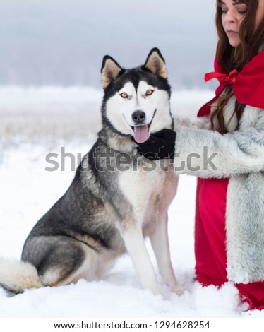 Red riding hood urban girl with tattoo with her best friend Husky dog