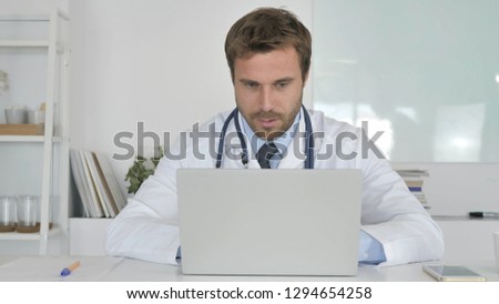 Doctor Working in Clinic On Laptop