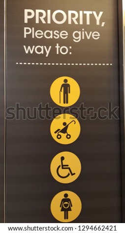 Courtesy sign at escalator - Priority Please give way to elderly, babies, disable and pregnant women