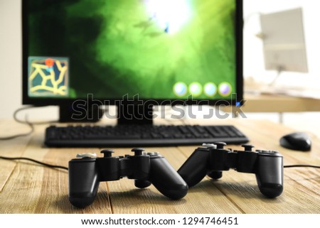 Game pads and computer on table in club