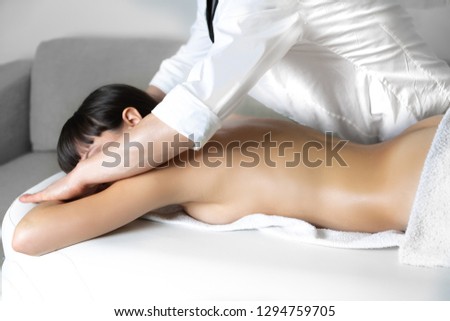 Pleasure of manipulation Physiotherapist  massage therapist working on the arms of an oiled woman with scented and warm oil. Alternative,ayurveda,masseur,body,business,card,closeup,concept,energy, 