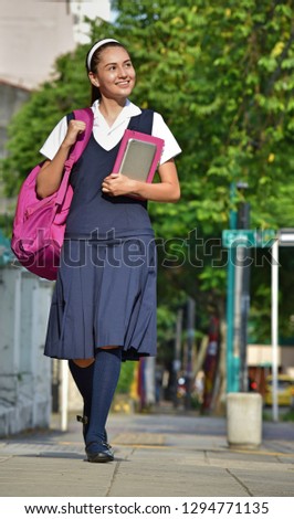 Catholic School Girl Walking On Sidewalk