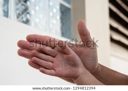 children hand on adult hand for helping